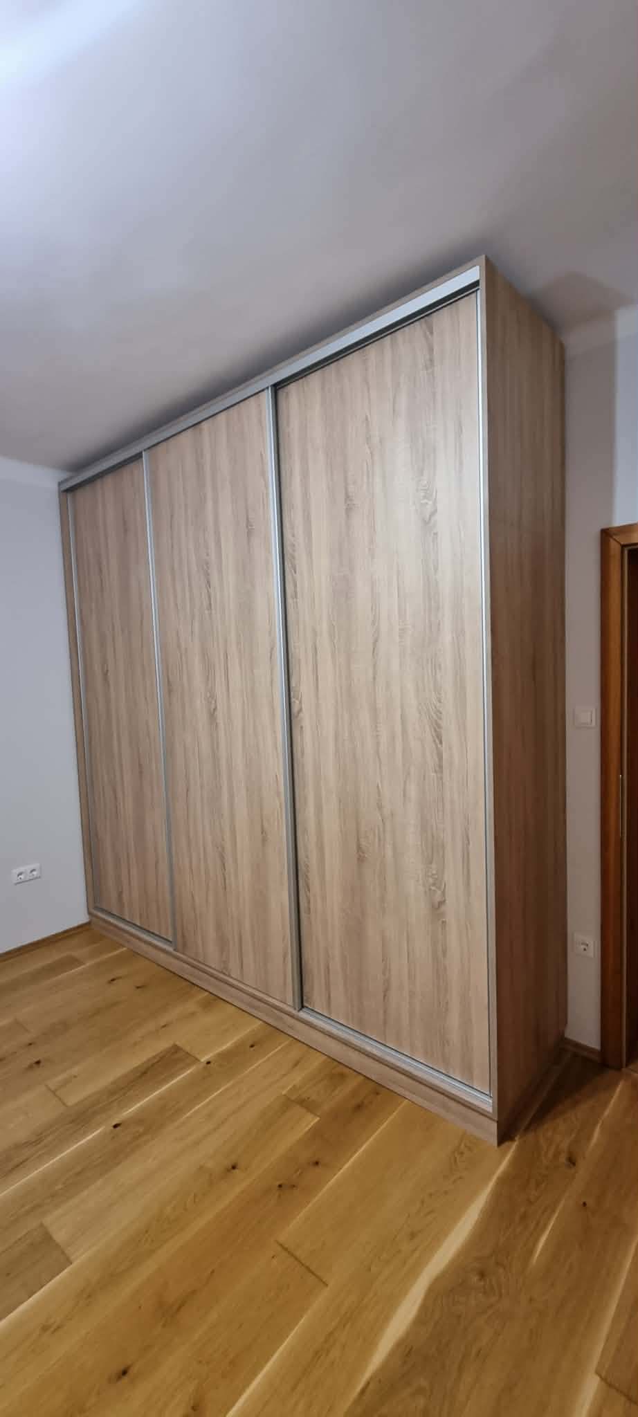 Világos tölgy tolóajtós gardróbszekrény padlótól mennyezetig a hálószobában